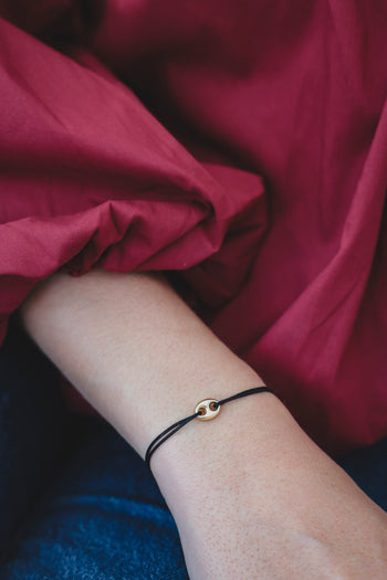 Bracelet en paracorde noire avec pendentif œil argenté et doré
