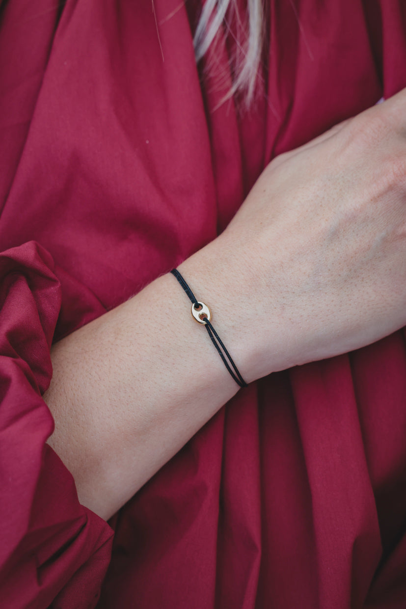 Bracelet en paracorde noire et pendentif œil argenté/doré au poignet