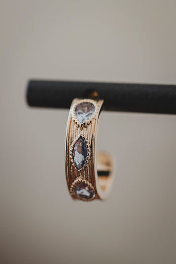Boucles d’oreilles créoles dorées au motif ajouré et pierres claires en forme de goutte